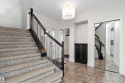 Staircase with dark wood newel posts and metal spindles - 