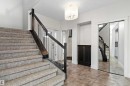 Staircase with dark wood newel posts and metal spindles - 17535 110 Street Nw, Edmonton, AB 
