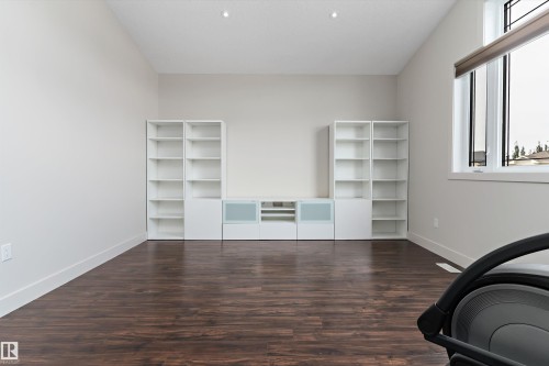 Vaulted ceiling, recessed lighting, wood-finish flooring, large window with transom, built-in shelving and media cabinet - 17535 110 Street Nw, Edmonton, AB 
