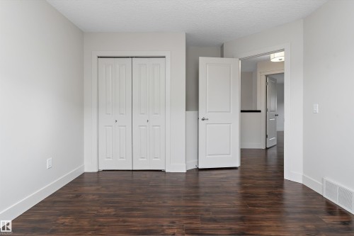 Wood-finish flooring with white trim - 17535 110 Street Nw, Edmonton, AB 