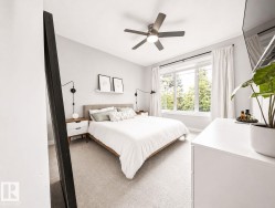 Recessed lighting, ceiling fan, expansive window, neutral wall paint, and light-toned carpet - 