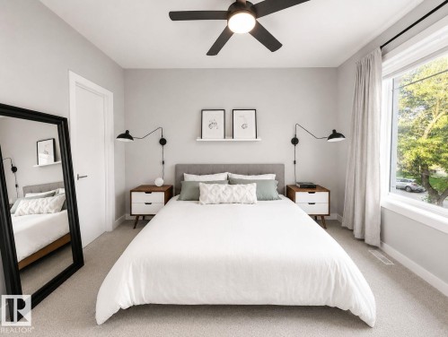 Light gray walls with a ceiling fan, a large window with white trim, and light-colored carpeting - 10516 76 Street Nw, Edmonton, AB 