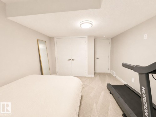Recessed lighting, light gray carpet, and a built-in closet with double doors - 10516 76 Street Nw, Edmonton, AB 