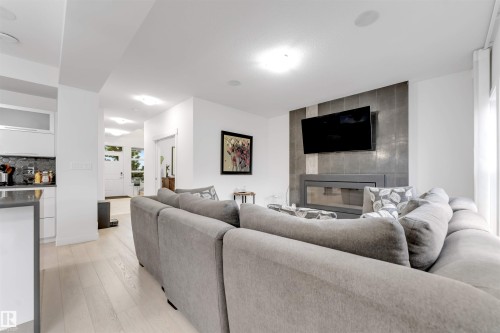 Light wood-finish flooring throughout - 718 Charlesworth Way Sw, Edmonton, AB 