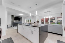 Central island featuring white cabinetry and a dark countertop - 