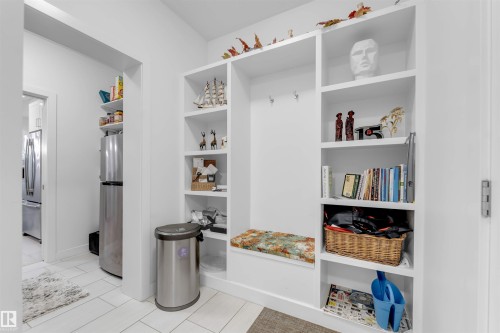 Built-in storage unit with shelving, coat hooks, and integrated seating - 718 Charlesworth Way Sw, Edmonton, AB 