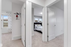 Light-colored carpeting throughout, white interior doors with chrome hardware, and white trim - 