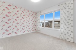 Light-toned carpeting, white trim, and a large window providing ample natural illumination - 