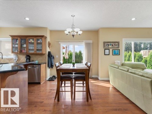 Wood-finish flooring throughout, recessed lighting, and a modern chandelier - 496 Ravine Court, Devon, AB 