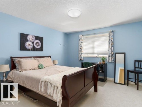 Recessed window featuring blinds, light wall-to-wall carpeting, and a flush mount ceiling light fixture - 496 Ravine Court, Devon, AB 