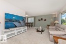Living area with light carpet flooring and a neutral color palette - 11415 56 Avenue Nw, Edmonton, AB 