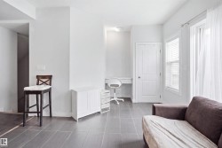 Recessed built-in desk, white paneled door, window with blinds, and tile flooring - 