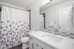 Vanity with an integrated sink, polished chrome faucet, and mosaic tile backsplash - 