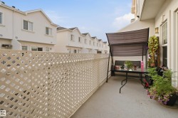 Outdoor balcony featuring a lattice privacy screen and stucco exterior - 