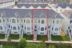 Multi-level townhouse with a dark shingle roof, light-colored exterior siding, and a front entry staircase - 