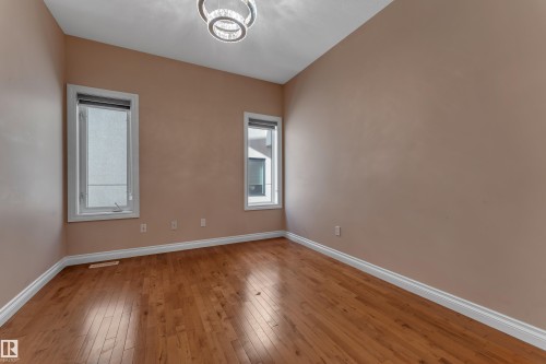 Hardwood flooring, contemporary ceiling light fixture, and two windows - 3455 29 Street Nw, Edmonton, AB 