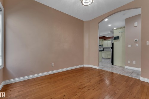 Hardwood flooring, arched doorway, recessed lighting, tile flooring, window with white trim - 3455 29 Street Nw, Edmonton, AB 