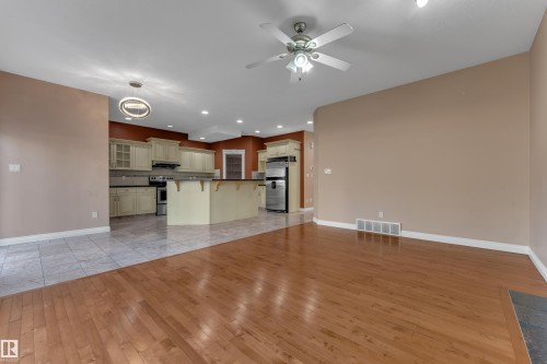 Hardwood flooring, tile flooring, ceiling fan, recessed lighting, and a kitchen island with seating - 3455 29 Street Nw, Edmonton, AB 