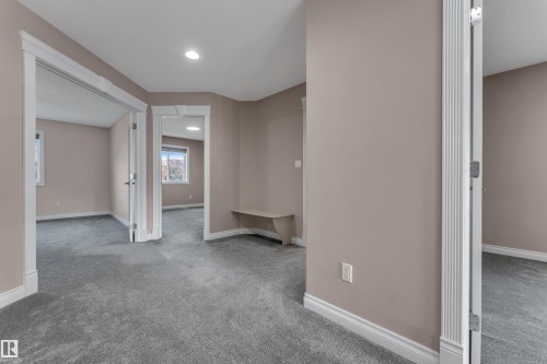 Neutral-toned interior with gray carpet flooring and recessed lighting - 3455 29 Street Nw, Edmonton, AB 