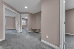 Neutral-toned interior with gray carpet flooring and recessed lighting - 