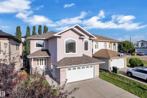 Stucco exterior with arched windows, an attached garage, and a covered front entry - 3455 29 Street Nw, Edmonton, AB 