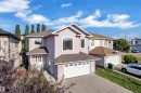 Stucco exterior with arched windows, an attached garage, and a covered front entry - 3455 29 Street Nw, Edmonton, AB 