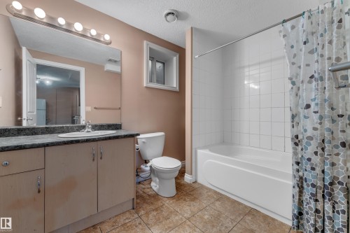 Vanity with an integrated sink, polished chrome faucet, and storage cabinetry - 3455 29 Street Nw, Edmonton, AB 