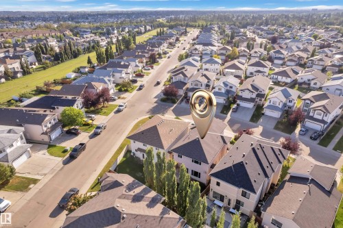 Aerial perspective of a developed residential area with multiple detached properties, paved streets, and mature landscaping - 3455 29 Street Nw, Edmonton, AB 