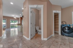 Tile flooring, built-in shelving, white trim, sliding glass doors, and recessed lighting - 