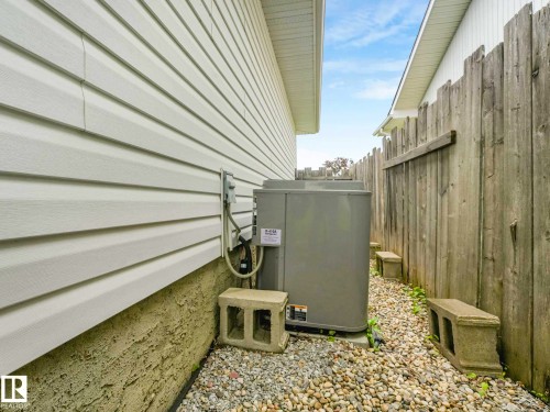 Vinyl siding exterior with a gravel foundation perimeter - 15916 88B Avenue Nw, Edmonton, AB 