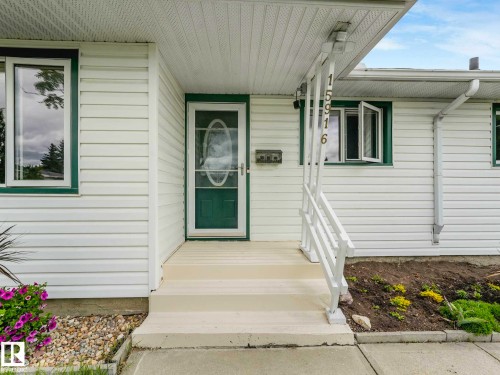 White horizontal siding with green trim accents - 15916 88B Avenue Nw, Edmonton, AB 