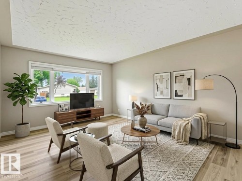 Expansive window, light wood-finish flooring, neutral wall tones, textured ceiling, and built-in window blinds - 15916 88B Avenue Nw, Edmonton, AB 