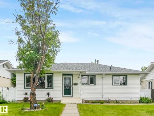 White horizontal siding exterior with dark green window trim and a matching dark green front door - 15916 88B Avenue Nw, Edmonton, AB 