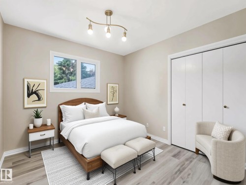Modern track lighting fixture, wood-finish flooring, white window trim, white closet doors with gold-finish hardware, and light neutral wall paint - 15916 88B Avenue Nw, Edmonton, AB 