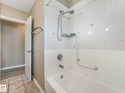 White tiled shower with a handheld showerhead and a built-in grab bar - 15916 88B Avenue Nw, Edmonton, AB 