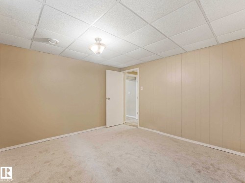 Neutral wall paint, drop ceiling with recessed lighting, and light-toned carpet flooring - 15916 88B Avenue Nw, Edmonton, AB 