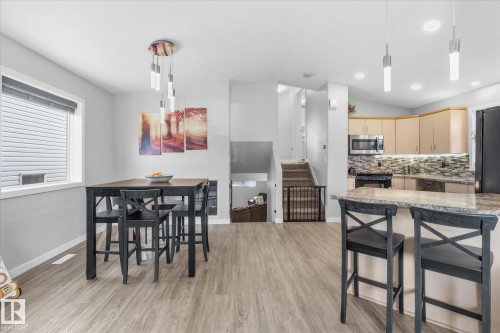 Wood-finish flooring throughout, complemented by light gray walls - 2109 37 Avenue Nw, Edmonton, AB 