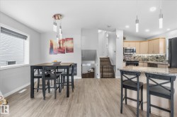 Wood-finish flooring throughout, complemented by light gray walls - 
