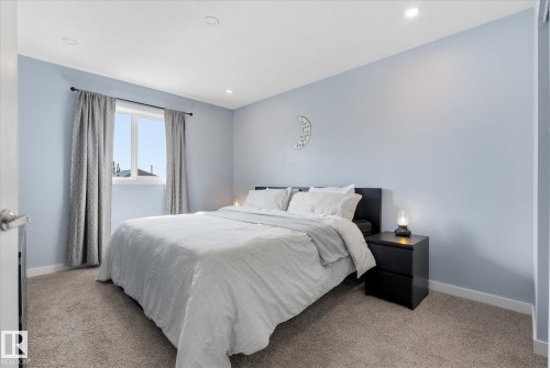 Recessed ceiling lighting, light blue wall finishes, and a window with a dark-finish curtain rod - 2109 37 Avenue Nw, Edmonton, AB 