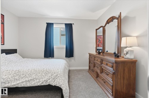 Carpeted flooring, a window with horizontal blinds, and smooth white walls - 2109 37 Avenue Nw, Edmonton, AB 