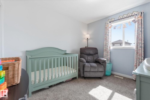 Wall-to-wall carpeting and a large window with natural light - 2109 37 Avenue Nw, Edmonton, AB 