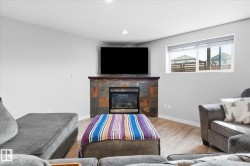 Fireplace with a stone surround and wood mantel - 