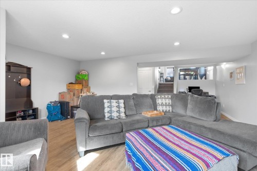 Recessed ceiling lighting, wood-finish flooring, light gray wall paint, and white trim - 2109 37 Avenue Nw, Edmonton, AB 