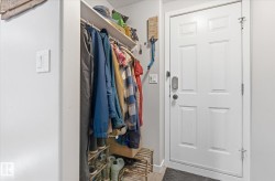 Panel entry door with a digital lock and a built-in closet with shelving and hanging rod - 