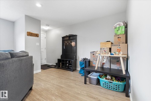 Light-toned wood-finish flooring, recessed lighting, and a built-in hall tree with storage compartments - 2109 37 Avenue Nw, Edmonton, AB 