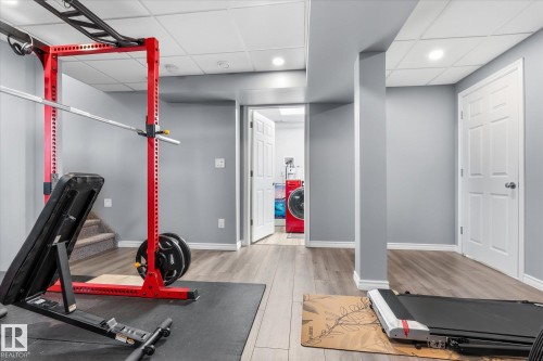 Wood-finish flooring, recessed lighting, and a paneled white door - 2109 37 Avenue Nw, Edmonton, AB 