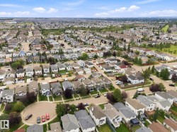 Expansive residential area featuring numerous single-family homes, mature trees, and paved streets - 