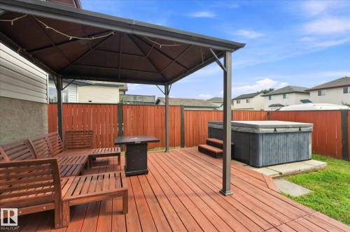 Expansive wooden deck featuring a gazebo, built-in hot tub, and privacy fencing - 2109 37 Avenue Nw, Edmonton, AB 