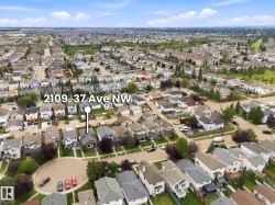 Aerial perspective showcasing a residential neighborhood with varied housing styles and established landscaping - 