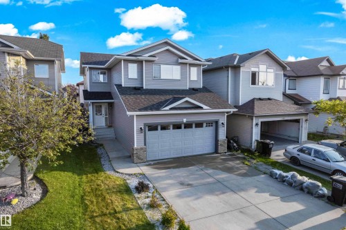 Contemporary two-story residence featuring light gray siding and a dark shingle roof - 3003 25 Avenue Nw, Edmonton, AB 